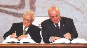 Eddie Fenech Adami signing Malta's EU accession treaty alongside Minister Joe Borg, 2003. Photo Credit: Times of Malta